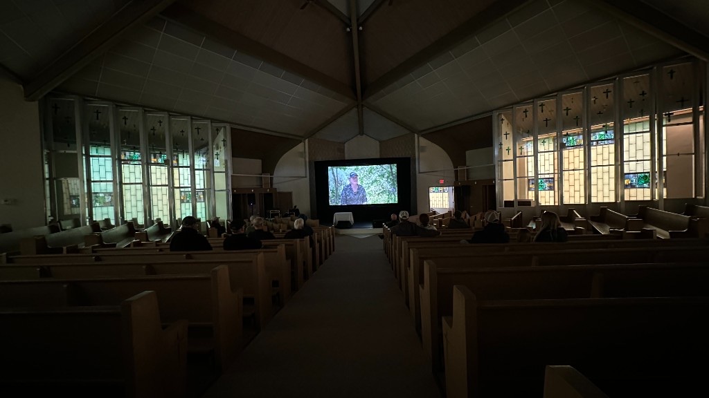 The Performing Arts Center during a screening, with the picture framed in black drape.