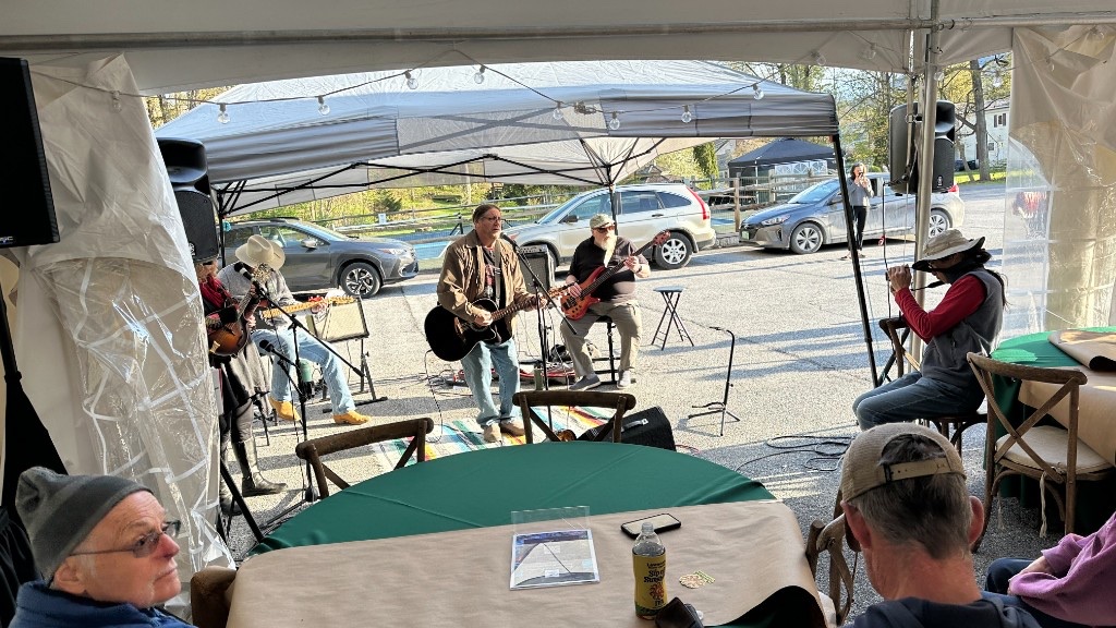 A band under Lawson’s tent, with speakers at either side.