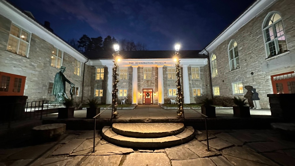 The Bennington Museum approach at dusk, columns lit and the front steps in the foreground.