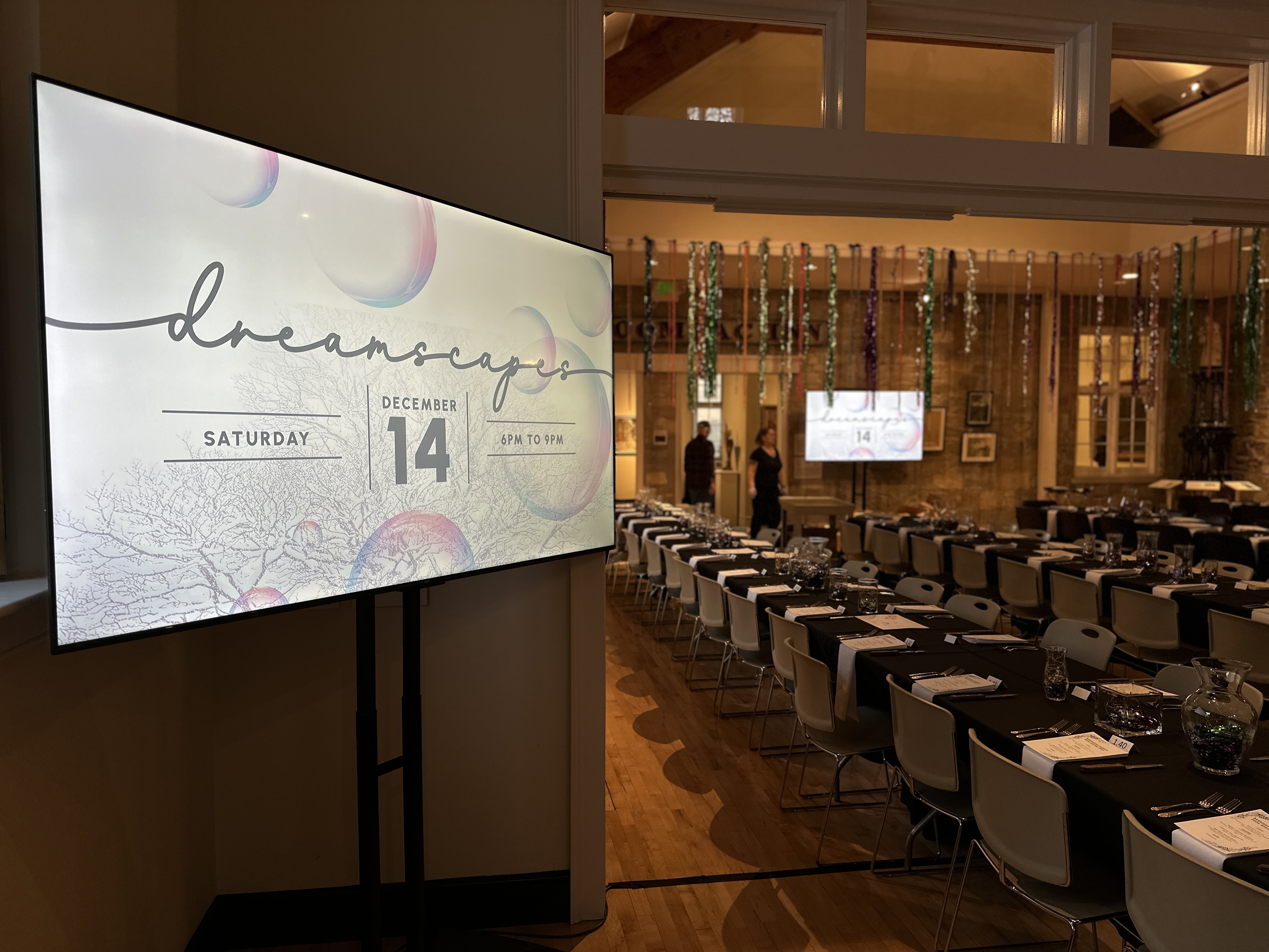 Guests at the Bennington Museum gala with custom event lighting against the collection.