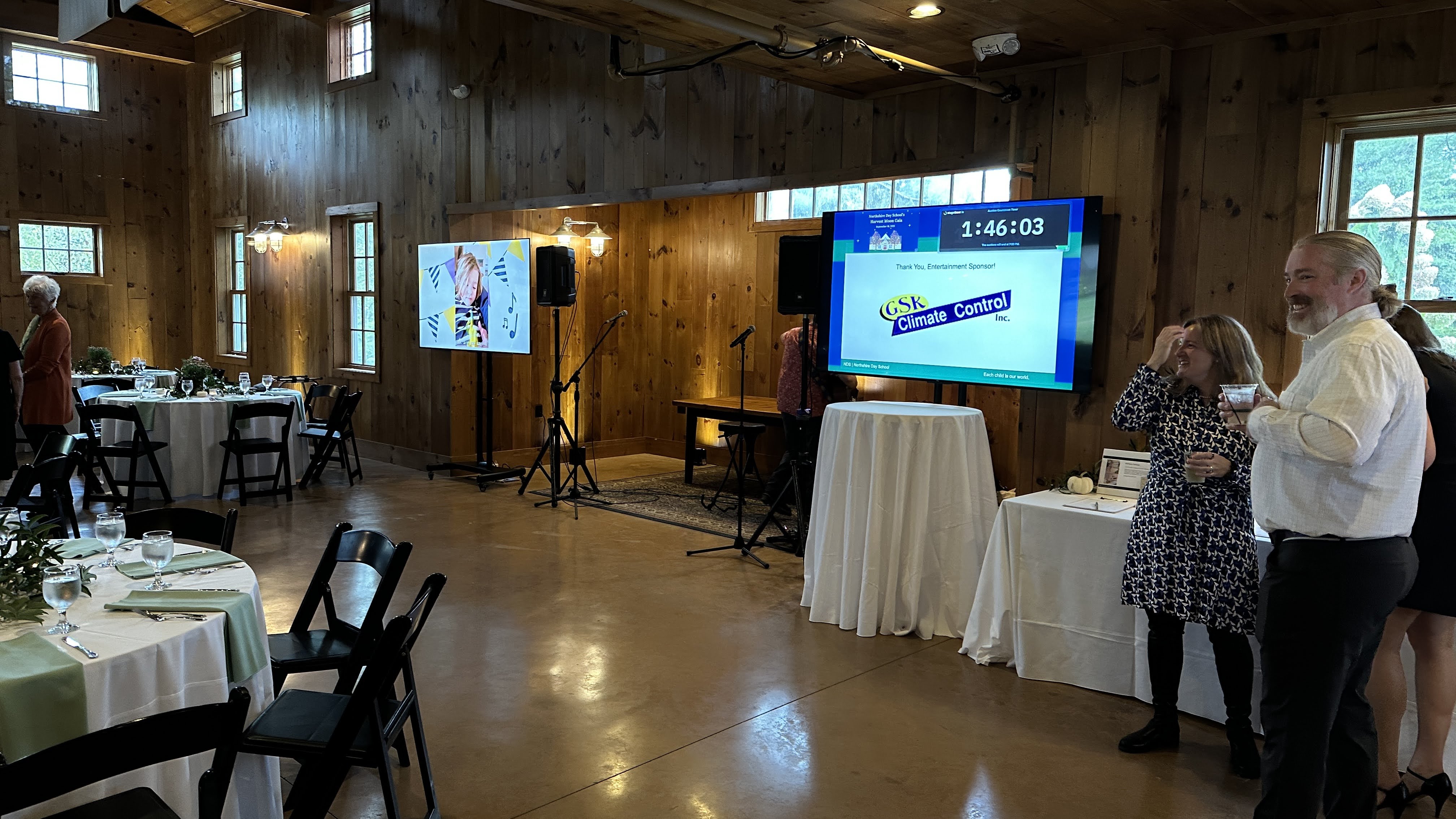 Live auction with wireless microphone and synchronized display systems.