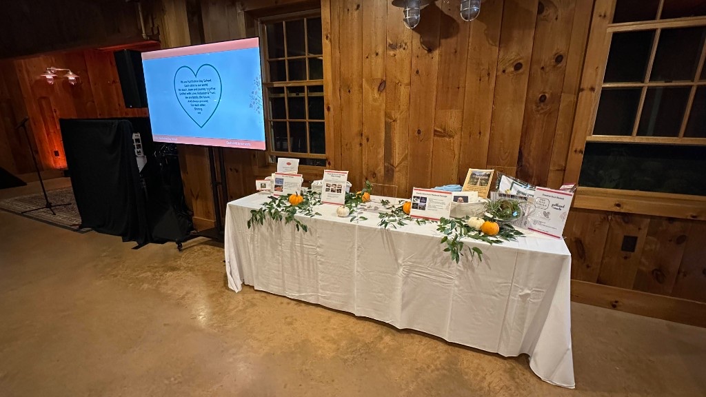 A 75-inch beside the silent auction, carrying Northshire Day School mission copy.