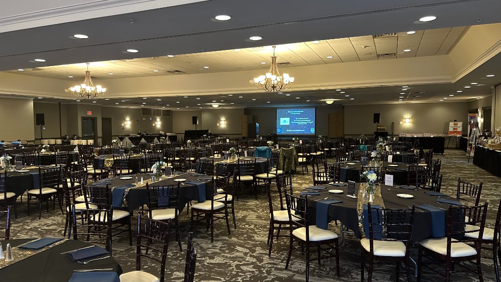The empty ballroom before doors, with the venue screen at the front of the room.