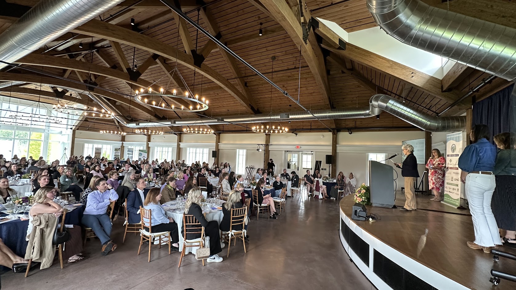 Women in Leadership Luncheon 2026 — title slide on 75-inch display, Lincoln Hall.
